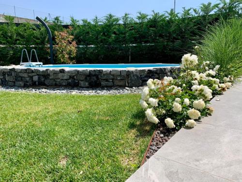 a garden with a stone bench and flowers in the grass at Villa Carlotta in Salionze