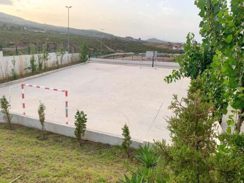 a basketball court with a basketball hoop on top of it at Océanica Marina Smir "avec accès piscine et une grande véranda" in M'diq