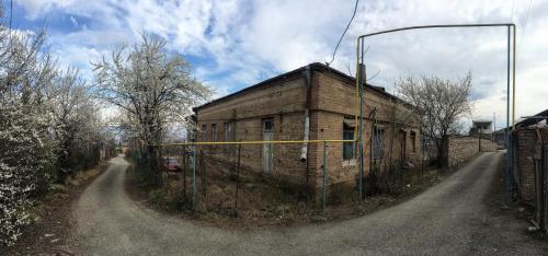 an old brick building on the side of a road at Gia's Home in Vazisubani in Vazisubani