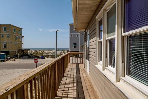 a porch of a house with a stop sign on it at Anchor Haven Ocean Views in Oak Island