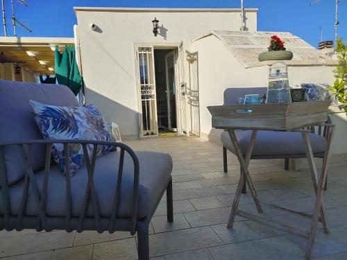 a table and a chair on a patio at ROSSINI GUEST HOUSE in Martina Franca