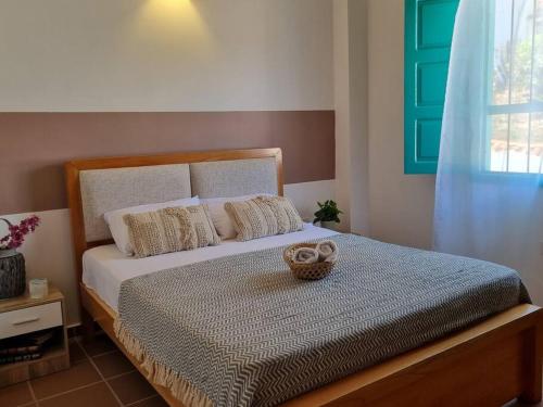 a bedroom with a bed with a basket on it at Casa Celeste in Zapatoca