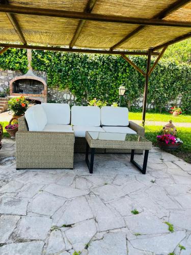 a couch and a coffee table on a patio at B&B L'Agapanto in Capri