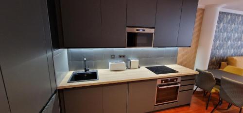 a kitchen with a sink and a counter top at Lugar de Alegría, Pegado a Playa, 2 Hab, 6 p, Wifi in Gijón