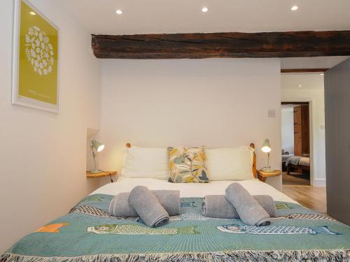 a bedroom with a large bed with pillows on it at Mill House in Lostwithiel