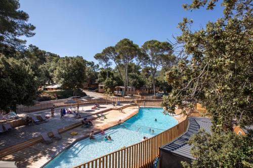 a pool at a resort with people in it at Huttopia Forêt de Janas in La Seyne-sur-Mer
