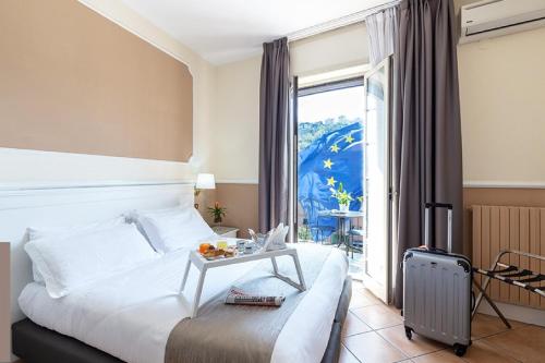 Ένα ή περισσότερα κρεβάτια σε δωμάτιο στο Hotel Leopardi