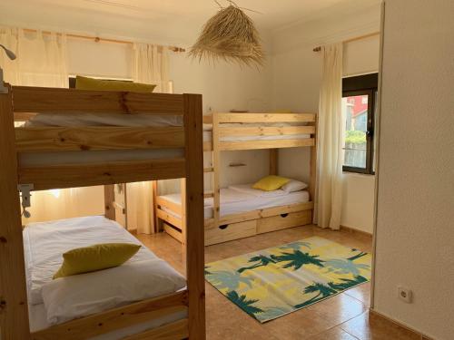 two bunk beds in a room with a window at casa loopez Hostel in Laredo