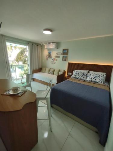 Ένα ή περισσότερα κρεβάτια σε δωμάτιο στο Perfeito Studio Praia