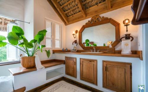 a bathroom with a sink and a mirror at Holiday Villa 34 in San Rafael del Yuma