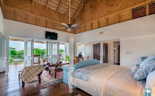 a bedroom with a large bed with a wooden ceiling at Holiday Villa 34 in San Rafael del Yuma