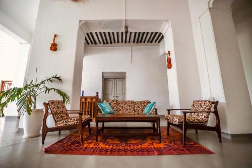 a living room with two chairs and a table at Balcony House in Zanzibar City