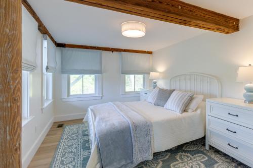 a bedroom with a bed and two windows at Unique Scituate Vacation Rental on Herring River! in Scituate
