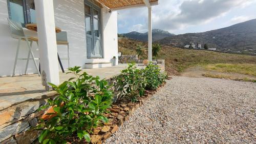 a porch of a house with mountains in the background at Scarpathia House in Katapola