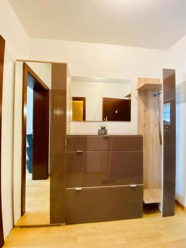 a kitchen with a large brown cabinet in a room at Schafberg nahe Zentrum Einzimmer Ferienwohnung in Bad Ischl