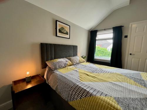 a bedroom with a bed and a window at 3 Bedroom Spacious House in Cardiff in Cardiff