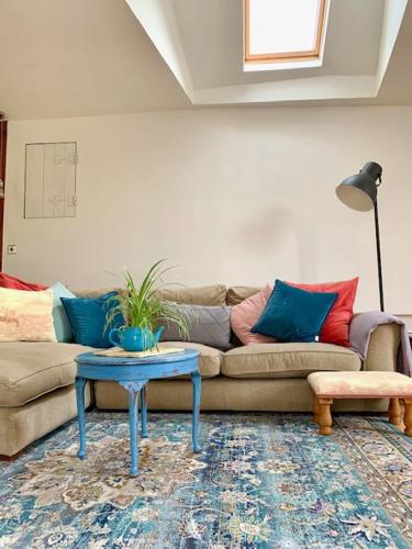 a living room with a couch and a table at Historic school room in Helston