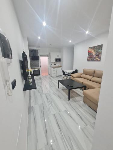 a living room with a couch and a table at Family House, CENTRO CIUDAD - 3 DORMITORIOS 6 1 0 3 1 0 8 3 1 in Ceuta