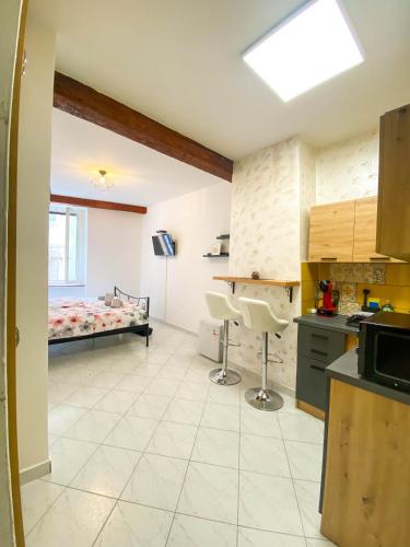 a room with a kitchen and a bed in it at Apartmani DA in Piran