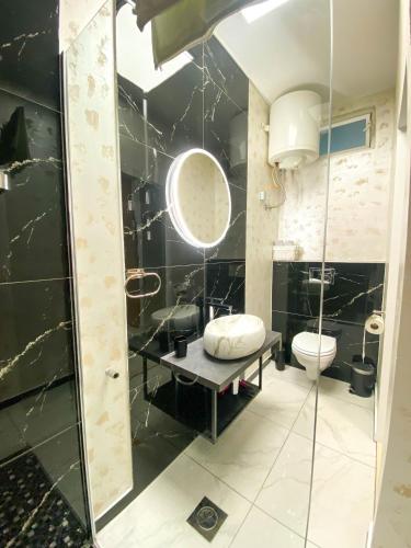 a bathroom with a glass shower and a toilet at Apartmani DA in Piran