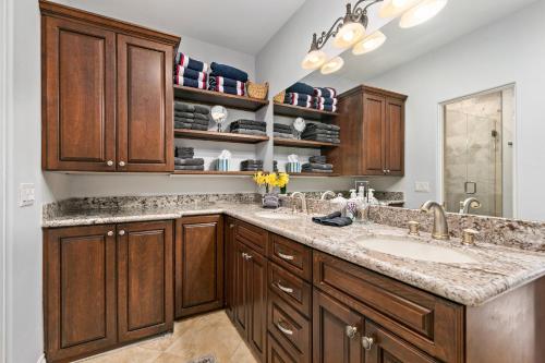 a kitchen with wooden cabinets and a sink at 683 Just inside the gates of the Resort - Golf & Premier Fitness Guests Welcome in Encinitas