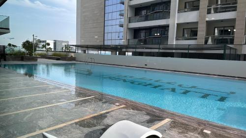 a large swimming pool in front of a building at VIP 2 bedrooms 5 minutes from Burj Khalifa in Dubai