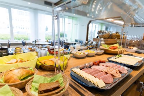 a buffet line with different types of food on a table at Hotel zur Sonne GmbH in Bodelshausen