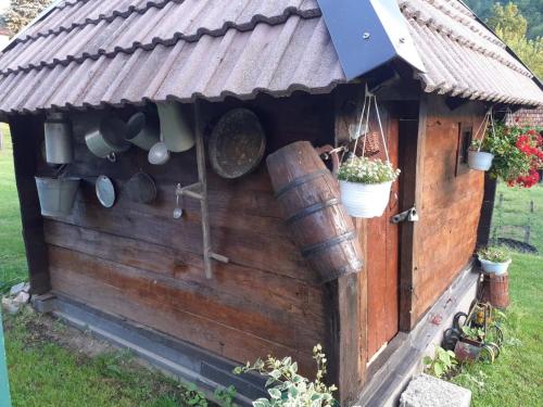 a wooden chicken house with pots and pans at Pantića avlija - Ethno household in Požega