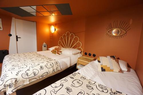 - une chambre avec 2 lits et une horloge murale dans l'établissement **** L'Odyssée Toulouse ****, à Toulouse