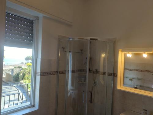 a shower stall in a bathroom with a window at Agriturismo Cascina Rio Rocca in San Lorenzo al Mare