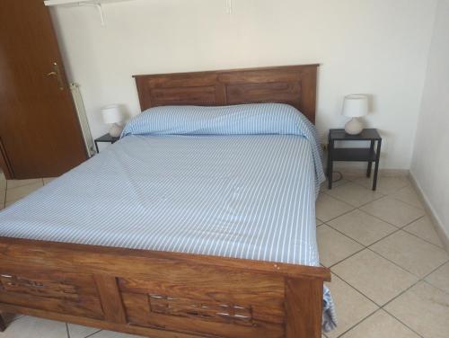 a bedroom with a bed with a wooden frame at Agriturismo Cascina Rio Rocca in San Lorenzo al Mare