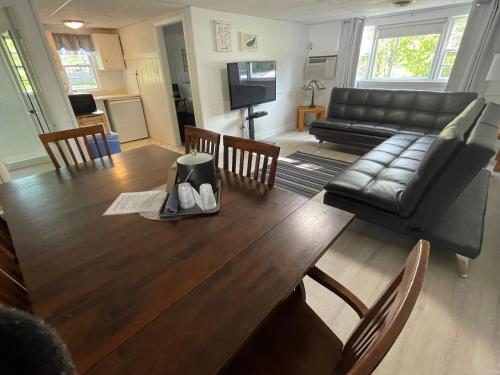 a living room with a wooden table and a couch at Kennebunkport Motor Lodge in Kennebunkport