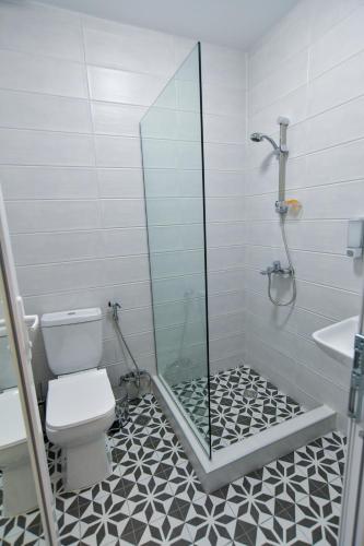 a bathroom with a shower and a toilet and a sink at Euro Hotel Kutaisi in Kutaisi