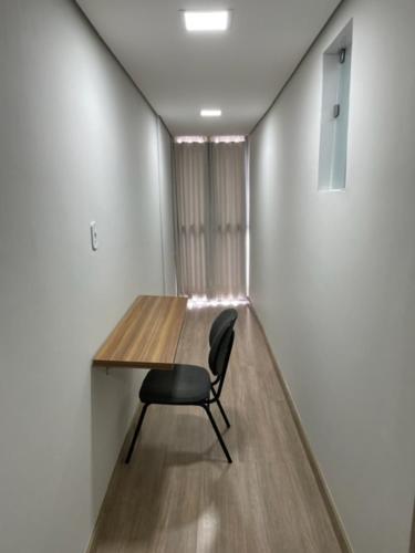 a chair sitting at a wooden table in a room at Xikus Palace Hotel in Guanhães