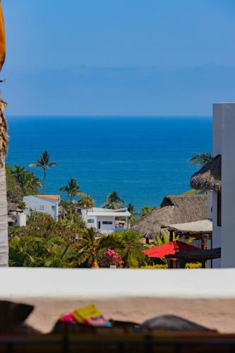 a view of the ocean from the balcony of a resort at Villa Monte in Sayulita