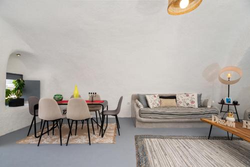 a living room with a table and chairs and a couch at 1812 Caves 'n Mansion in Karterados