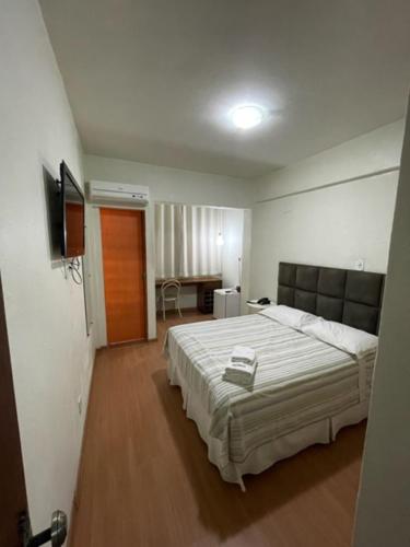 a bedroom with a large bed in a room at Xikus Palace Hotel in Guanhães