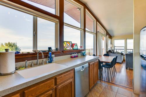 a kitchen with a sink and a counter with windows at McKinleyville Getaway with Hot Tub and Ocean Views! in McKinleyville