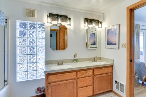 a bathroom with a sink and two mirrors at McKinleyville Getaway with Hot Tub and Ocean Views! in McKinleyville