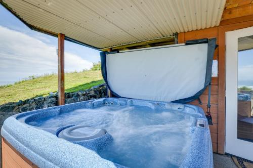 a jacuzzi tub in a house with a window at McKinleyville Getaway with Hot Tub and Ocean Views! in McKinleyville
