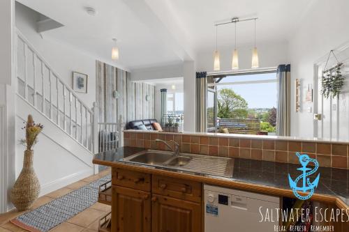 a kitchen with a sink and a counter top at Stella Marina in Paignton