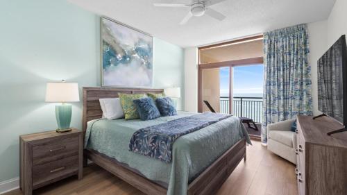 a bedroom with a bed with a view of the ocean at North Beach Resort and Villas #1916 in Myrtle Beach