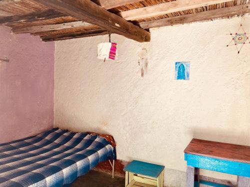 a room with a bed and a table in it at Estación de sueños Casa de Silvia in San Rafael de las Torres