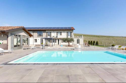 a swimming pool in front of a house at Dimora San Carlo in Roddi