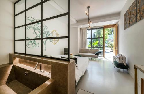 a bathroom with a large tub and a large window at Horti 14 Borgo Trastevere Hotel in Rome