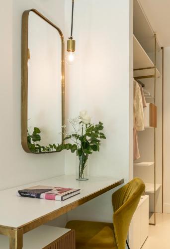 a dressing table with a mirror and a chair at Horti 14 Borgo Trastevere Hotel in Rome