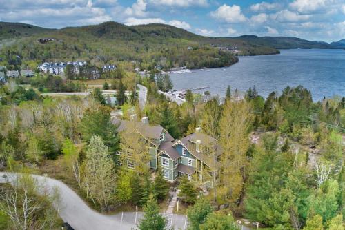 an aerial view of a house on the shore of a lake at Tremblant Les Eaux by Rendez-Vous Mont-Tremblant in Mont-Tremblant