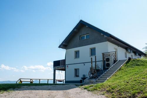 a white house on top of a hill at Apartmaji Gračner in Dramlje