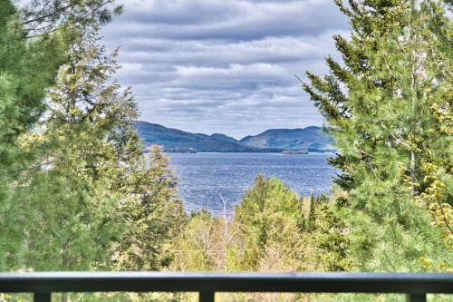 a view of a lake between two trees at Tremblant Les Eaux by Rendez-Vous Mont-Tremblant in Mont-Tremblant