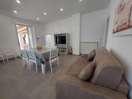 a living room with a couch and a table at Tropical Palm Villa in Monopoli